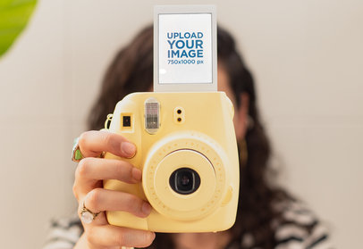 Polaroid Frame Mockup of a Woman Holding Her Colorful Instant Camera