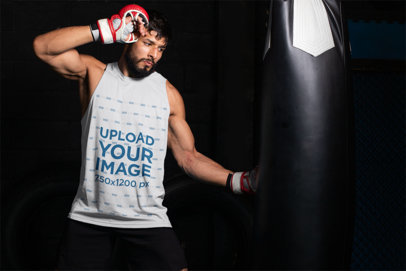 Sleeveless Shirt Mockup of an MMA Fighter Hitting a Punching Bag