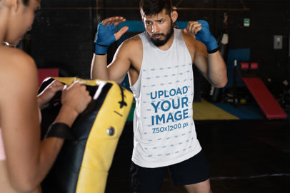 Sleeveless Shirt Mockup of an MMA Fighter Hitting a Dummy 