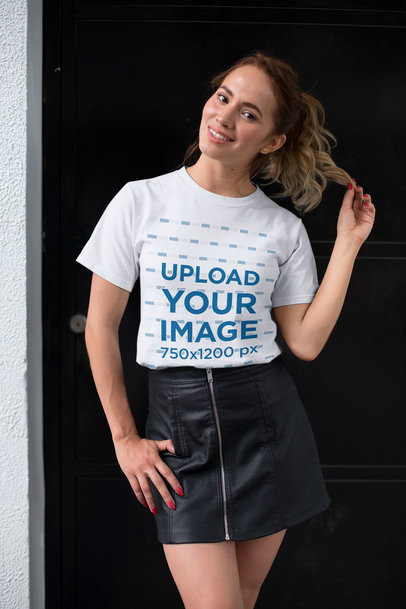 Tee Mockup of a Woman with a Leather Skirt Playing with Her Hair