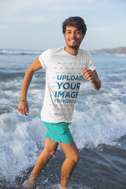 T-Shirt Mockup of a Young Man Playing in the Waves