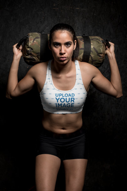 Sports Bra Mockup of a Sportive Woman Holding a Weight Bag