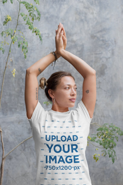 Mockup of a Yoga Teacher Wearing a Tee While in a Pose