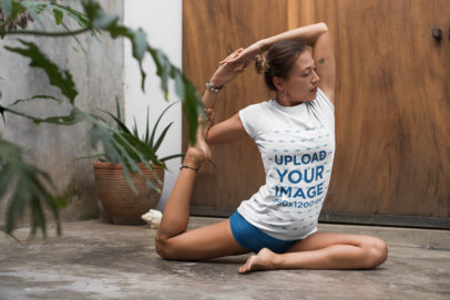 Tee Mockup of a Woman with a Hair Bun Doing Yoga