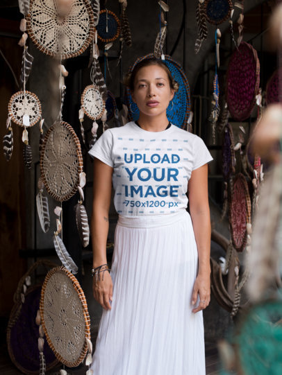 Tee Mockup of a Woman Standing by Hanging Dream Catchers