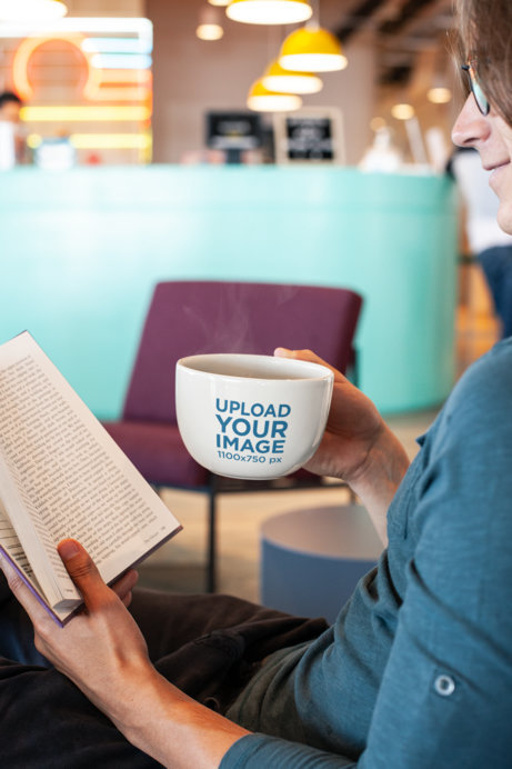 24 oz Mug Mockup of a Man Reading a Book at a Coffee Shop