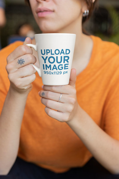 Coffee Mug Mockup Featuring a Finger-tattooed Lady with an Orange Blouse 26447