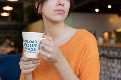 Coffee Mug Mockup of a Pensive Woman with Finger Tattoos 26448
