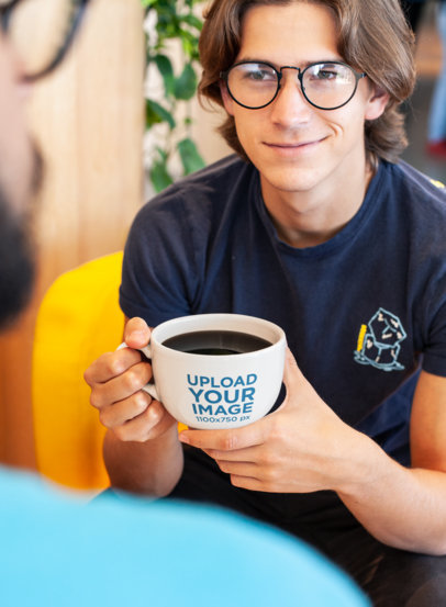 Over-The-Shoulder Mockup of a Young Man with Glasses Holding a Coffee Mug 26510