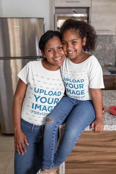 Tee Mockup of a Mom Hugging Her Daughter at Their Home's Kitchen