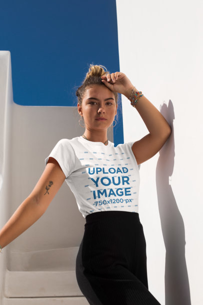 Tee Mockup of a Woman with a Hair Bun in a Sunny Stairway