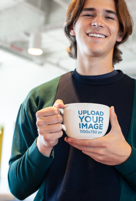 Mockup of a Smiling Man with Long Hair Holding a Coffee Mug