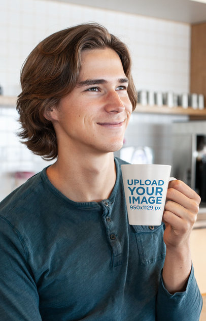 Coffee Mug Mockup of a Smiling Young Man in a Kitchen 26515