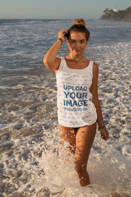 Tank Top Mockup of a Young Woman Posing by Crashing Waves at the Beach