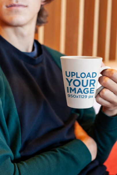 Mockup of a Serious Man Holding an 11 Oz Coffee Mug Against Wooden Tiles 26523