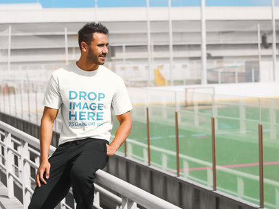 Young Man Sitting on a Fence T-Shirt Mockup 