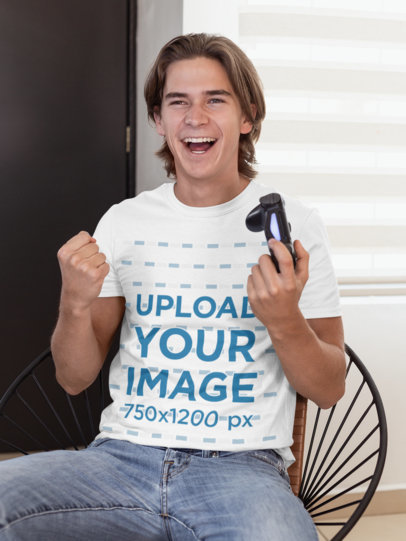T-Shirt Mockup of a Cheerful Gamer Man Holding a Play Station Controller