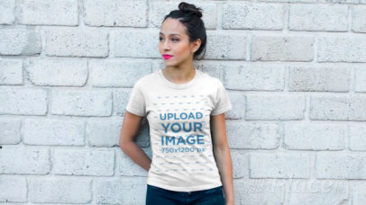 T-Shirt Video Featuring a Young Woman Posing Against a Gray Brick Wall 