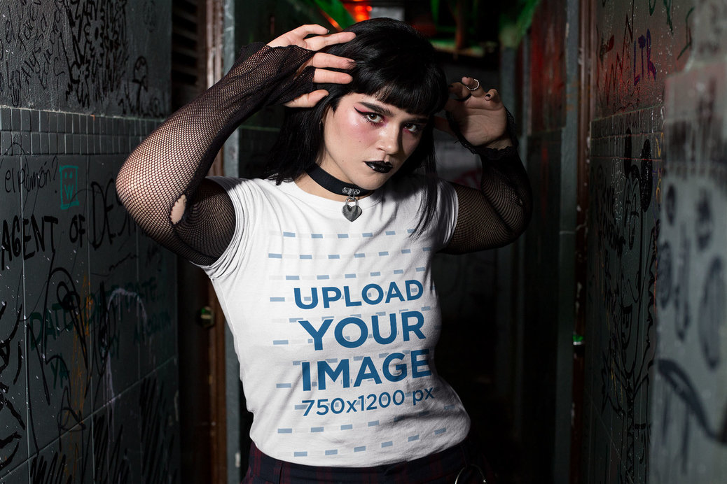 Tee Mockup Featuring a Goth Woman at a Dark Alley Wearing Fishnet Arm Warmers
