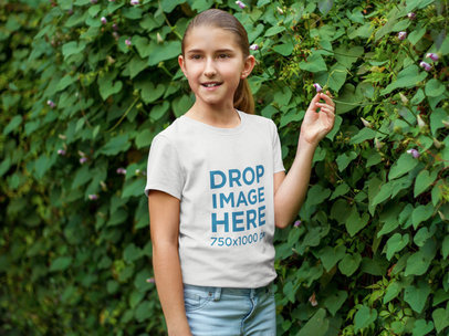 Young Girl Standing Next to a Green Wall T-Shirt Mockup a7923