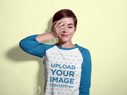 Mockup of a Woman Wearing a Raglan Tee in a Studio