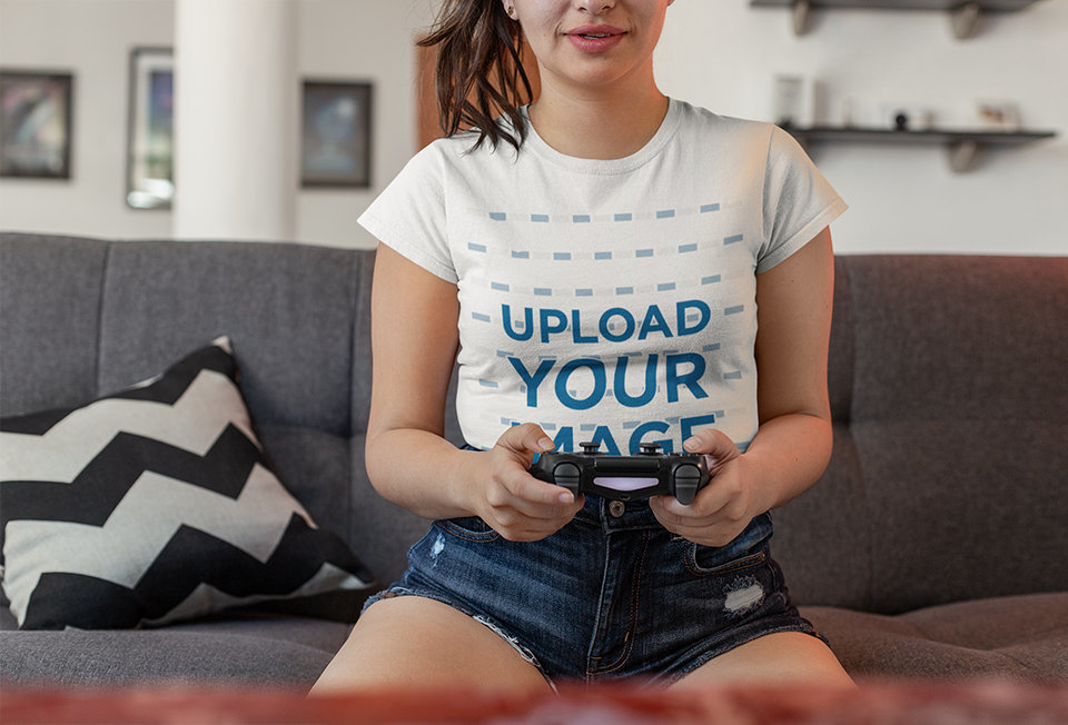 T-Shirt Mockup of a Female Gamer Playing in Her Living Room