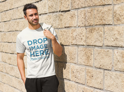 Young Man Standing Next to a Brick Wall T-Shirt Mockup
