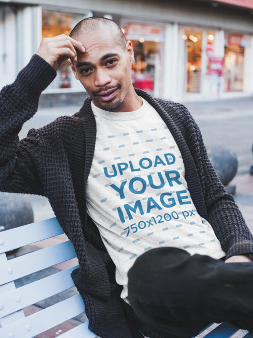 Heathered T-Shirt Mockup of a Pensive Man on a City Bench