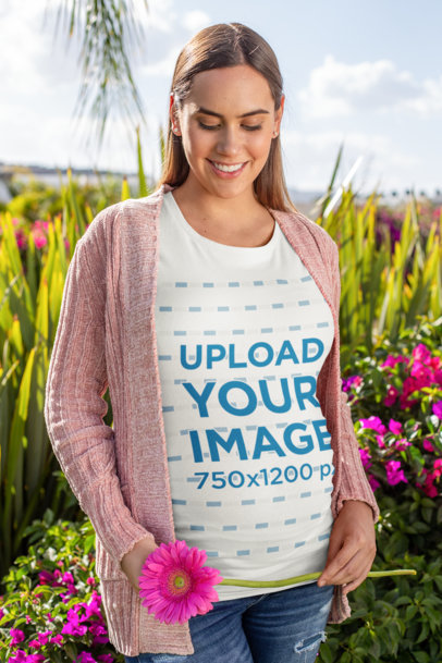 T-Shirt Mockup of a Pregnant Woman in a Flowery Scenario