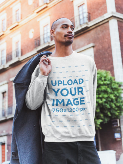 Heather Sweatshirt Mockup of a Man Holding a Coat at the City