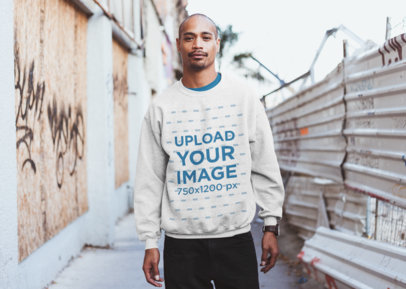 Mockup of a Serious Man Wearing a Heathered Sweatshirt in an Alley 