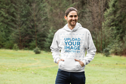 Pullover Hoodie Mockup of a Smiling Man in an Open Green Area