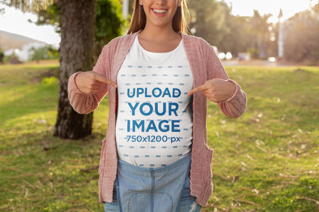 Mockup of a Happy Pregnant Woman Pointing at Her T-Shirt