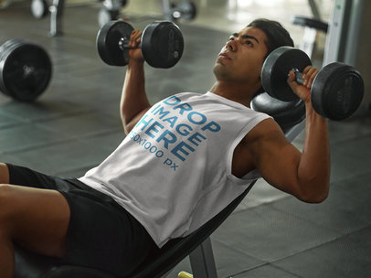 Athletic Man Lifting Weights at the Gym in a Sleeveless Shirt