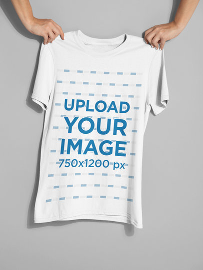 Mockup of Two Hands Holding a T-Shirt