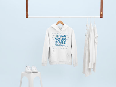 Mockup of a Hoodie Hanging With Only White Clothes