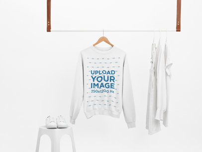 Mockup of a Sweatshirt Hanging With Only White Clothes