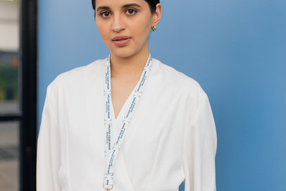 Lanyard Mockup Featuring a Young Woman Looking at the Camera 