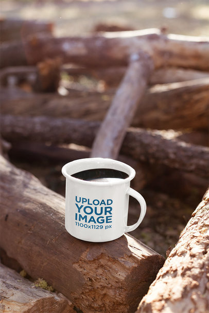 Mockup of a 12 Oz Enamel Mug on a Log at the Woods