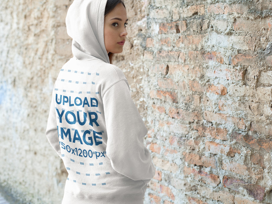 Placeit - Hoodie Mockup of a Woman Standing in Front of a Brick Wall