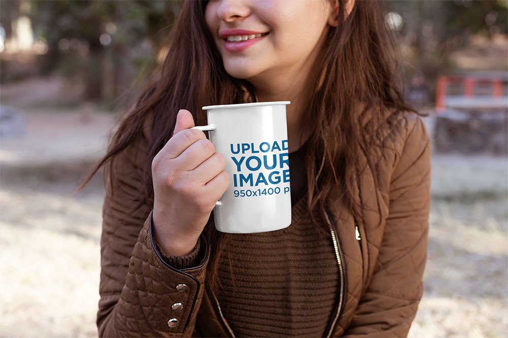 Mockup of a Woman Holding a 21 Oz Enamel Mug at the Outdoors