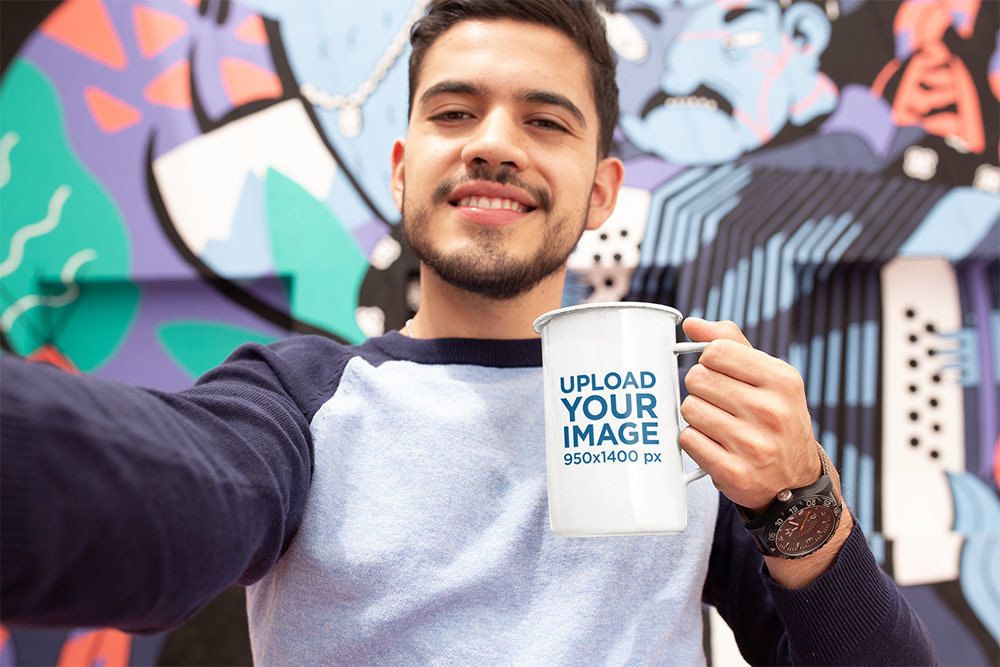 Mockup of a Man Taking a Selfie with a 21oz Enamel Coffee Mug