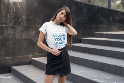 T-Shirt Mockup of a Young Woman Standing by an Urban Stairway