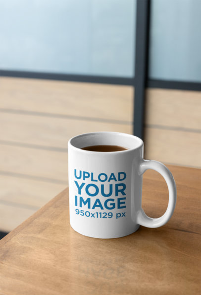 Mockup of an 11 Oz Coffee Mug on a Wooden Table 