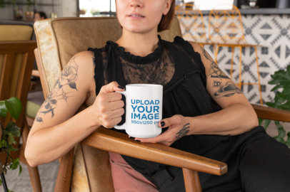 Mockup of a Tattooed Young Woman Holding a 15 Oz Mug