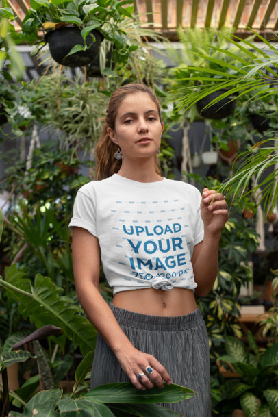 Mockup of a Woman with a Knotted T-Shirt at a Greenhouse