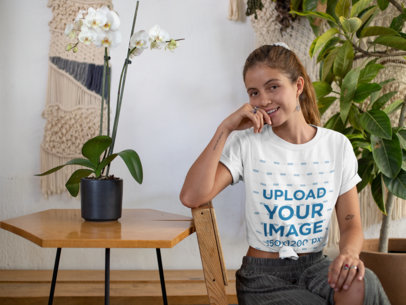 Mockup of a Woman with a Knotted T-Shirt in a Rustic Living Room