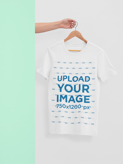 Mockup of a T-Shirt Hanging from a Hand