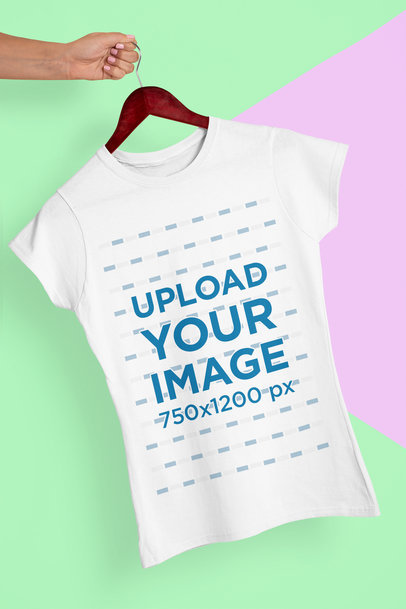 Mockup of a Hand Holding a Hanger with a Woman's T-Shirt 