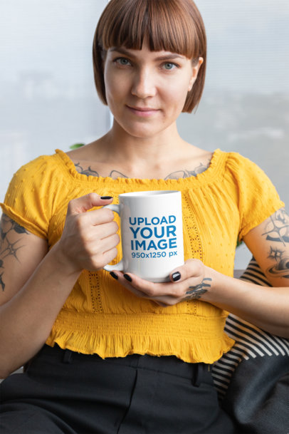 Mockup of a Short-Haired Tattooed Woman Showing a 15 Oz Mug 